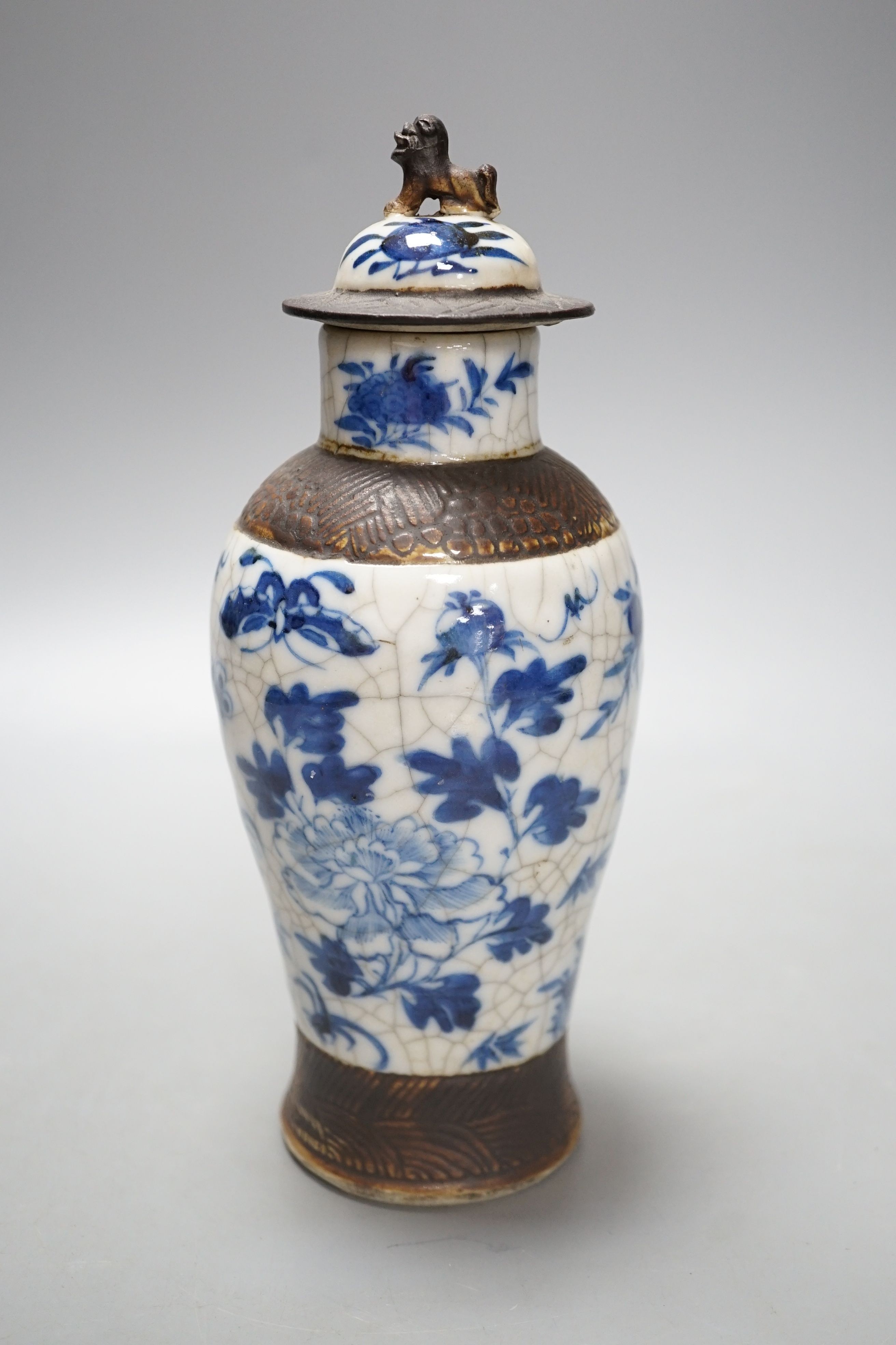 A Chinese blue and white crackle ware vase, c.1900, 22cms high including cover.